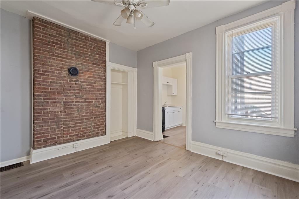 481 Union Street Verona, PA 15147 - Photo 7 of 25 an empty room with wooden floor chandelier fan and windows