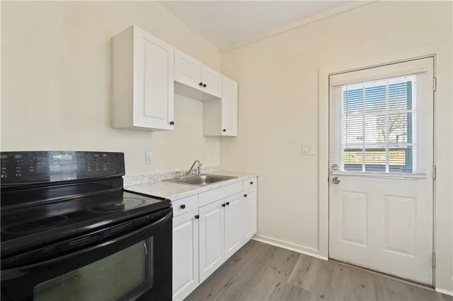 a kitchen with a stove and white cabinets