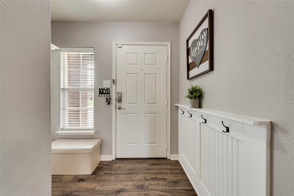 149 Cattlemans Creek Road Newark, TX 76071 - Photo 2 of 39 Front entry/mud room area with laminate floors and custom paneling at 149 Cattlemans Creek Rd in the Chisholm Springs neighborhood in Newark, TX 76071