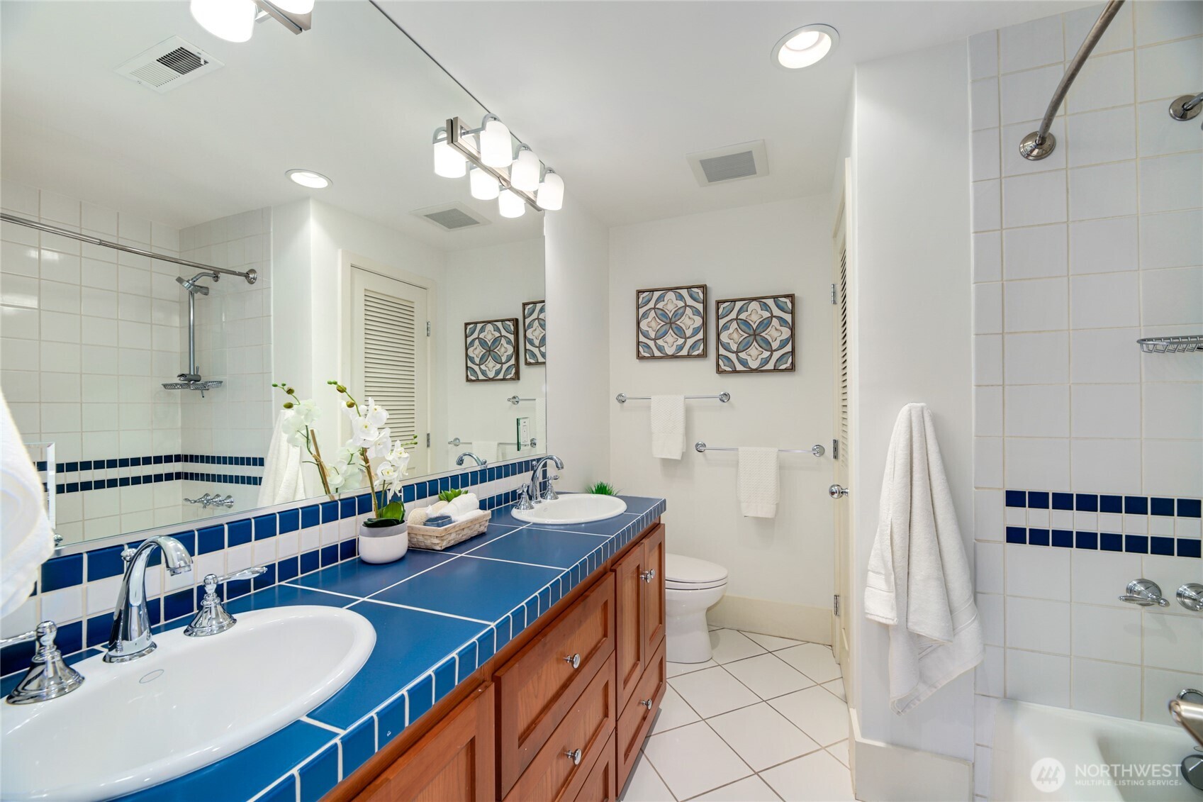6116 152nd Avenue Northeast Redmond, WA 98052 - Photo 23 of 34 a bathroom with a sink double vanity granite tub shower and a mirror