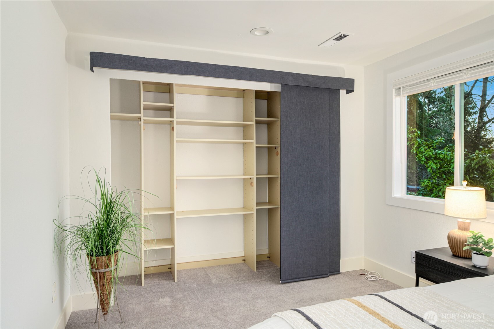 6116 152nd Avenue Northeast Redmond, WA 98052 - Photo 27 of 34 a living room with a potted plant and a window