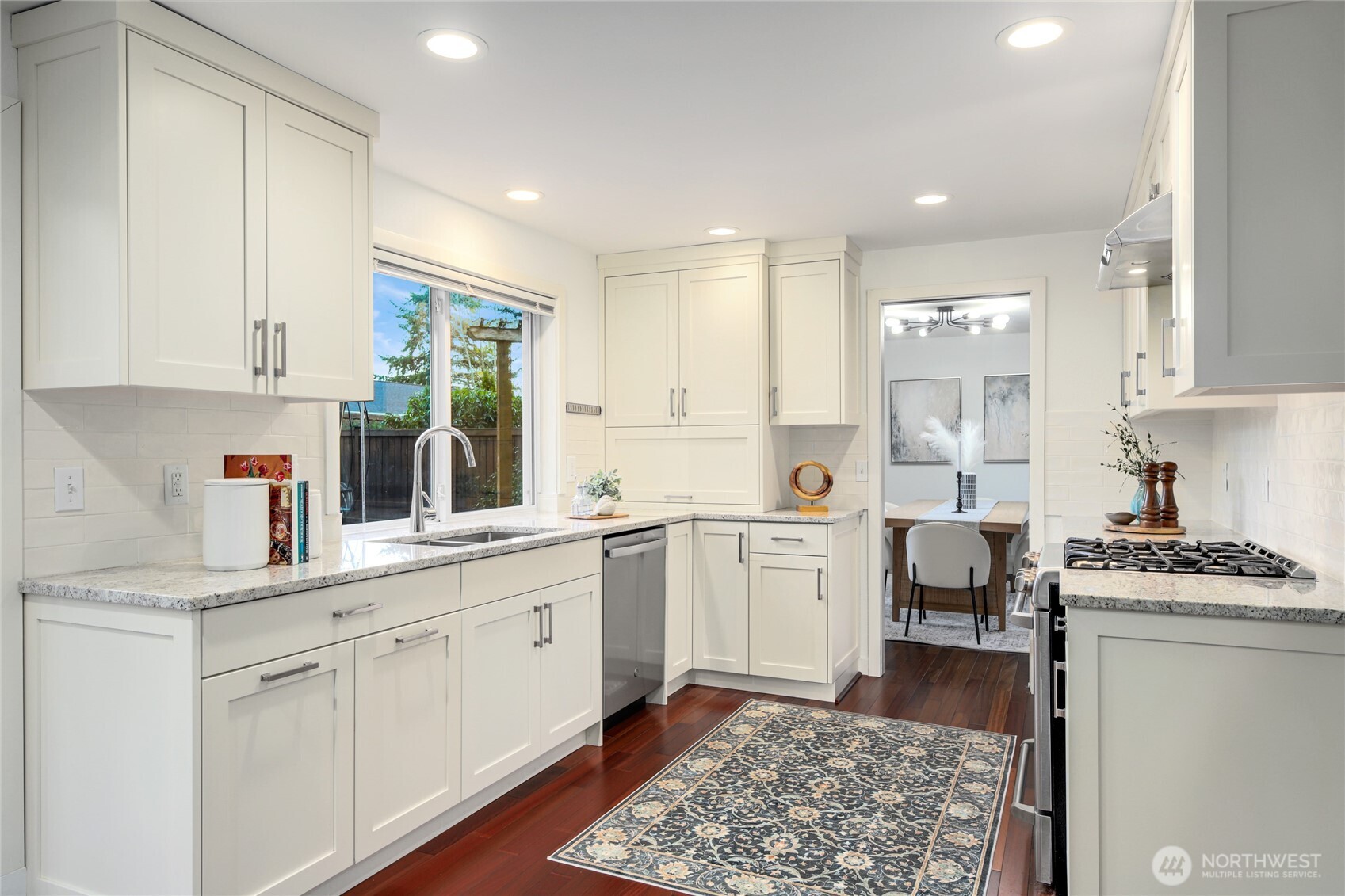 6116 152nd Avenue Northeast Redmond, WA 98052 - Photo 10 of 34 a kitchen with a sink stove top oven and cabinets