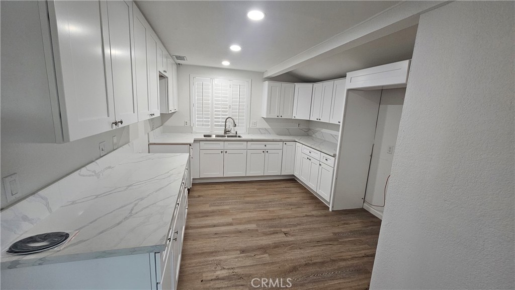 a large kitchen with white cabinets