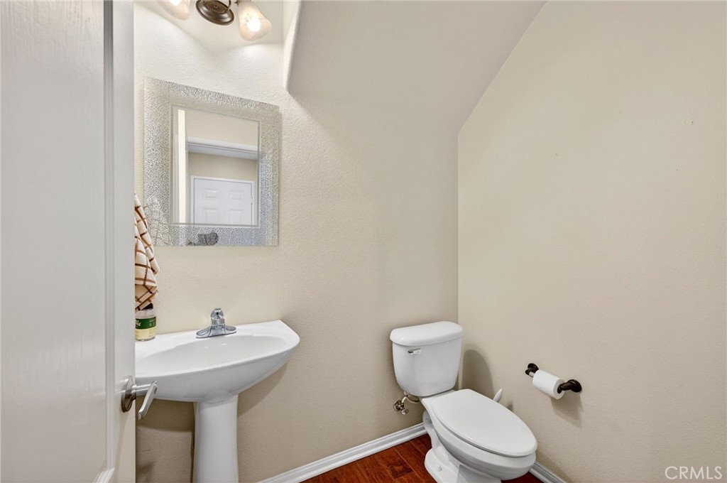 30505 Canyon Hills Road, Unit 1903 Lake Elsinore, CA 92532 - Photo 11 of 36 a bathroom with a toilet sink and mirror