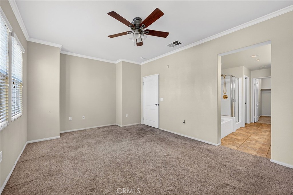 30505 Canyon Hills Road, Unit 1903 Lake Elsinore, CA 92532 - Photo 15 of 36 an empty room with ceiling fan and window