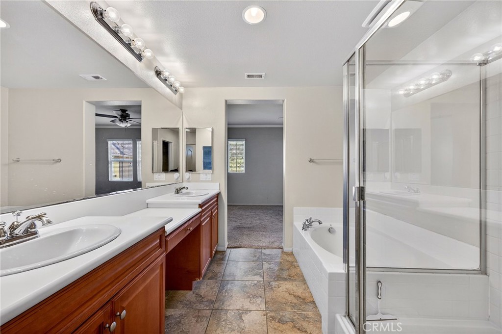 30505 Canyon Hills Road, Unit 1903 Lake Elsinore, CA 92532 - Photo 17 of 36 a spacious bathroom with a double vanity sink mirror double and shower