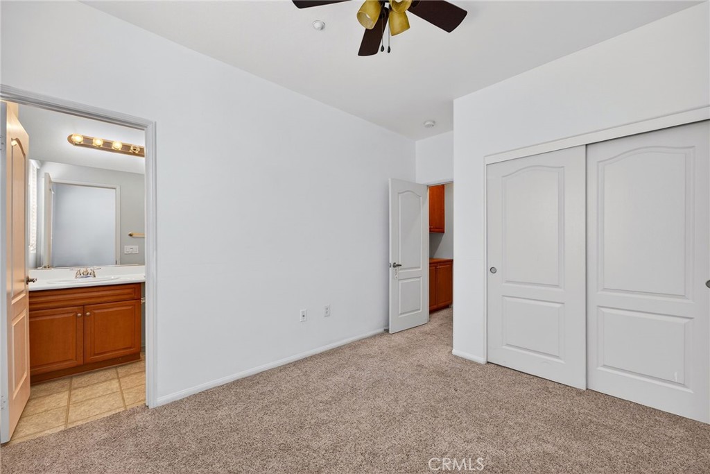 30505 Canyon Hills Road, Unit 1903 Lake Elsinore, CA 92532 - Photo 23 of 36 an empty room with closet and mirror