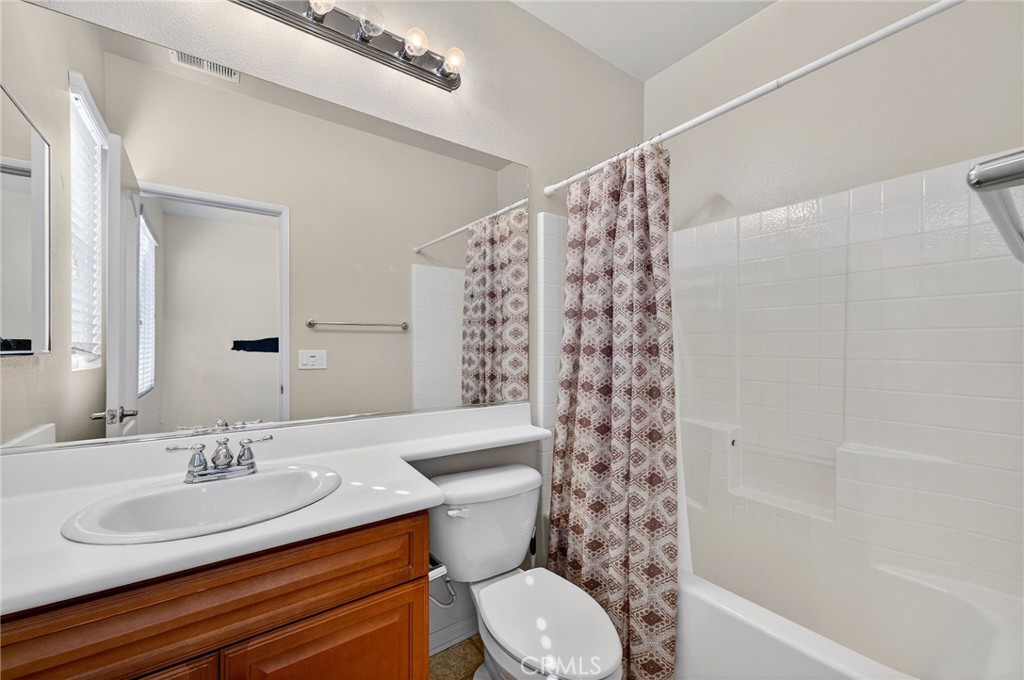 30505 Canyon Hills Road, Unit 1903 Lake Elsinore, CA 92532 - Photo 24 of 36 a bathroom with a sink a toilet and shower
