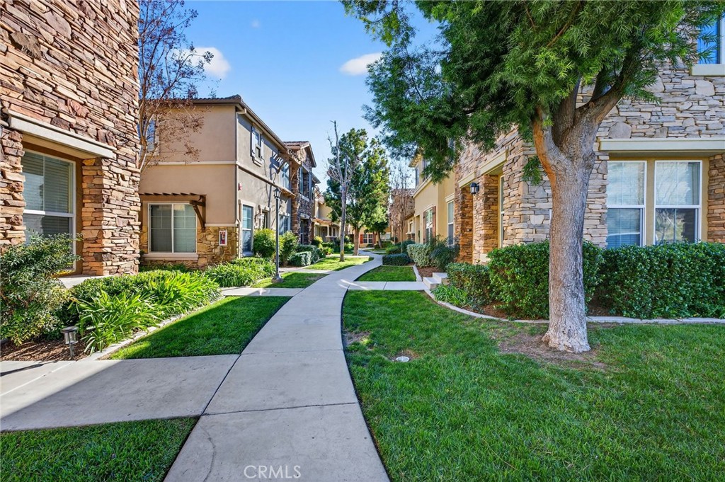 30505 Canyon Hills Road, Unit 1903 Lake Elsinore, CA 92532 - Photo 34 of 36 a view of a brick house with a yard