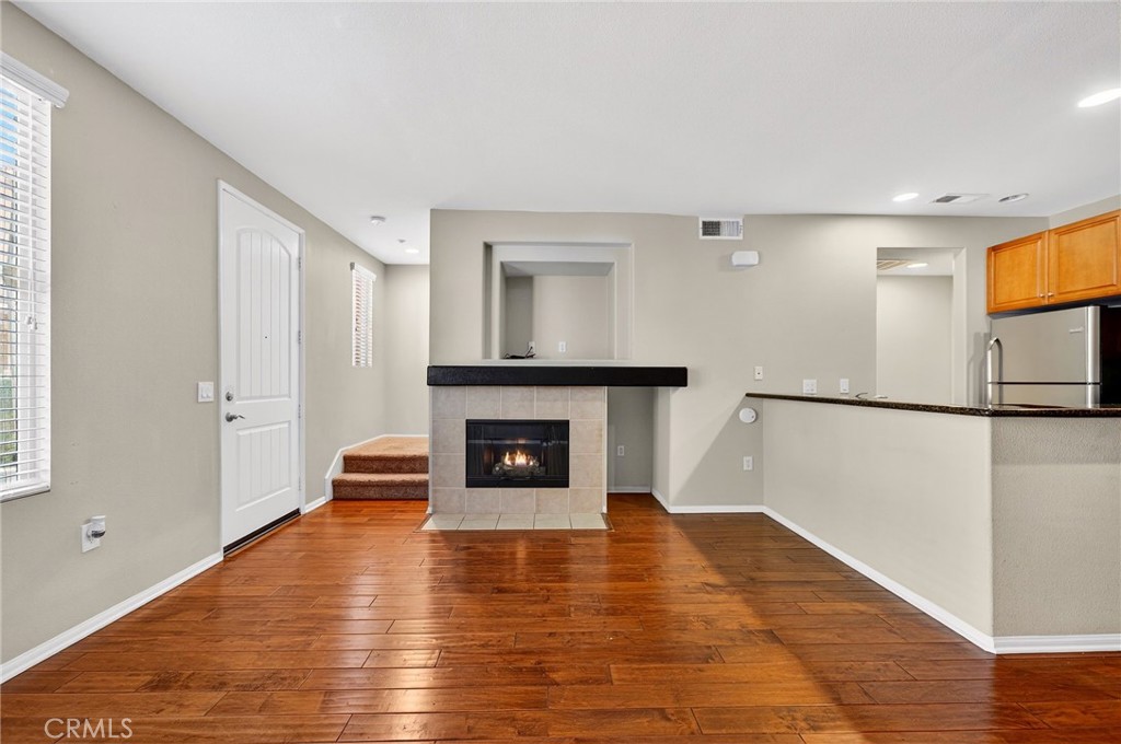 30505 Canyon Hills Road, Unit 1903 Lake Elsinore, CA 92532 - Photo 5 of 36 a view of a livingroom with wooden floor a fireplace and window
