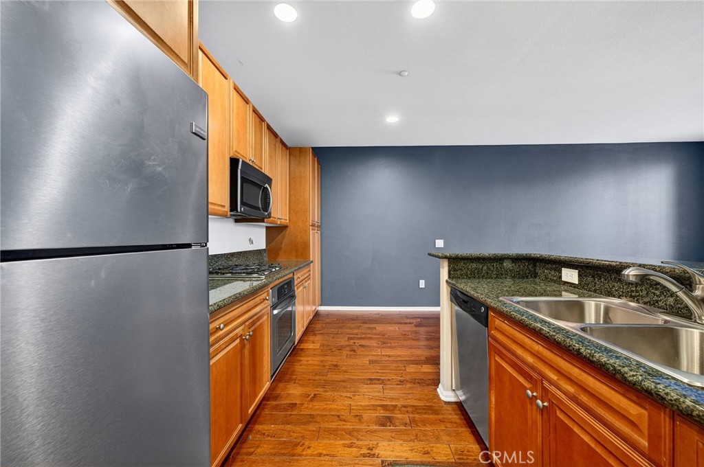 30505 Canyon Hills Road, Unit 1903 Lake Elsinore, CA 92532 - Photo 10 of 36 a kitchen with stainless steel appliances granite countertop a sink a stove and a refrigerator