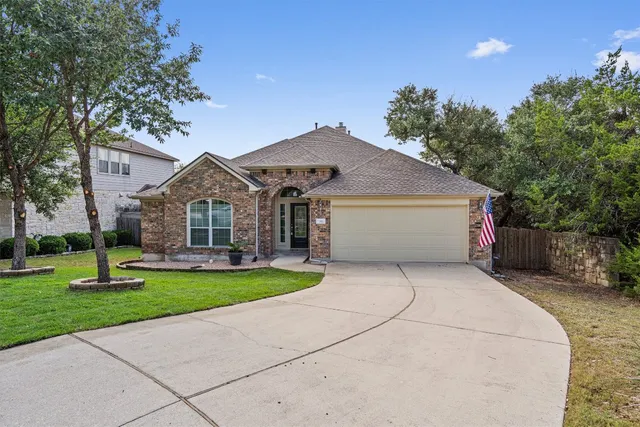 a front view of house with yard and green space