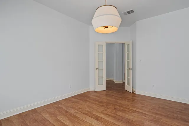 an empty room with wooden floor