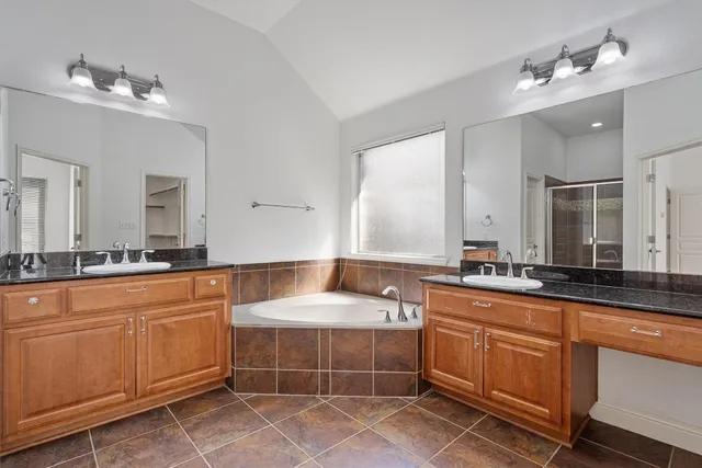 a large bathroom with double sink and a large mirror