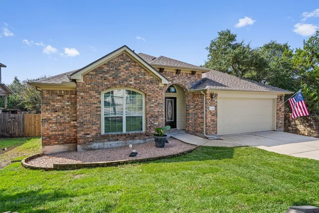 a view of a house with a yard patio and fire pit