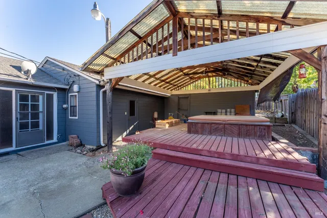 a view of a patio with table and chairs potted plants with wooden floor