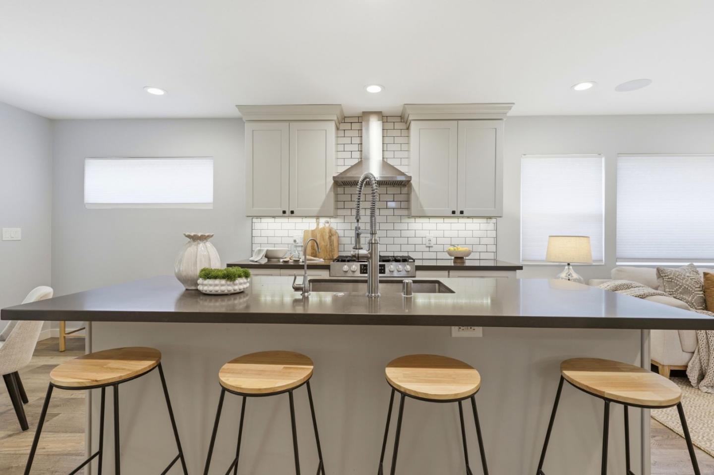 140 Second Street Gilroy, CA 95020 - Photo 11 of 33 a kitchen with stainless steel appliances granite countertop a table chairs sink and white cabinets