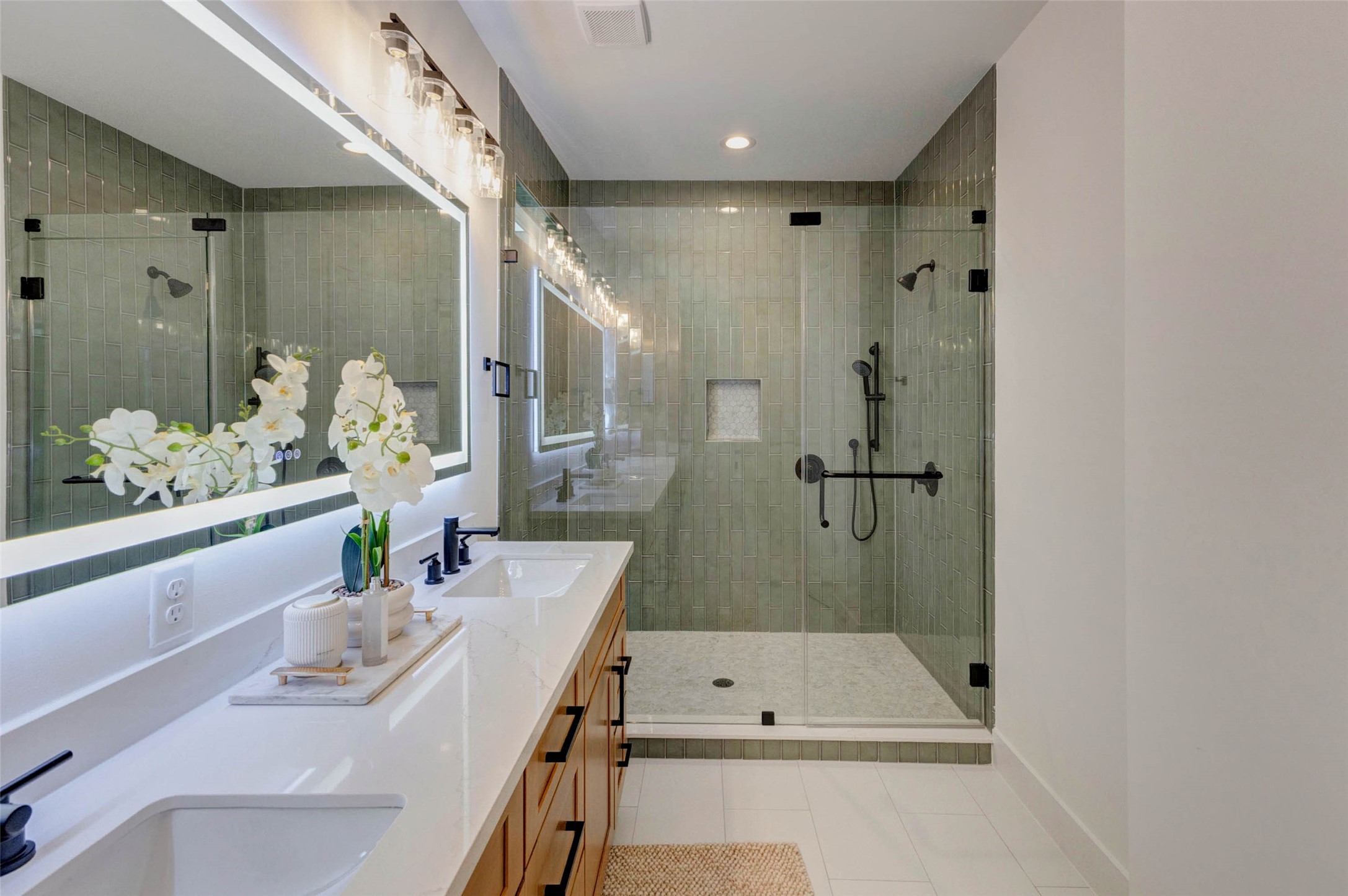 3309 St Emanuel Street Houston, TX 77004 - Photo 31 of 47 Luxurious en-suite with a spacious shower featuring dual shower heads and elegant custom tile work.