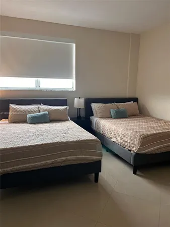 a bedroom with bed and window