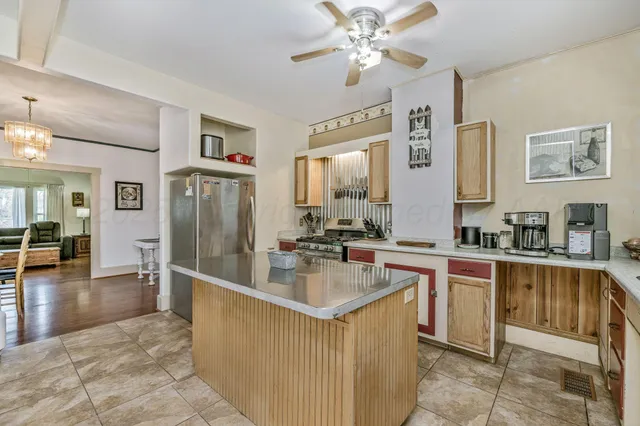 a kitchen with stainless steel appliances granite countertop a sink and a refrigerator