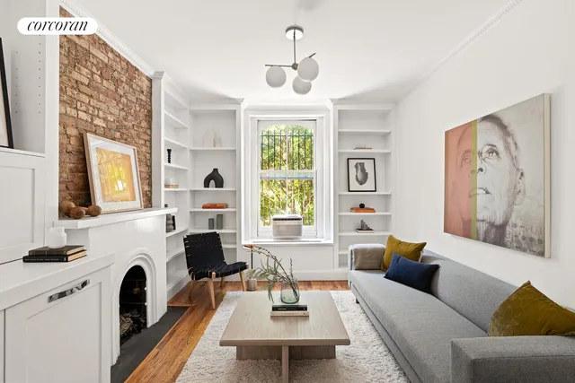 a living room with furniture fireplace and window