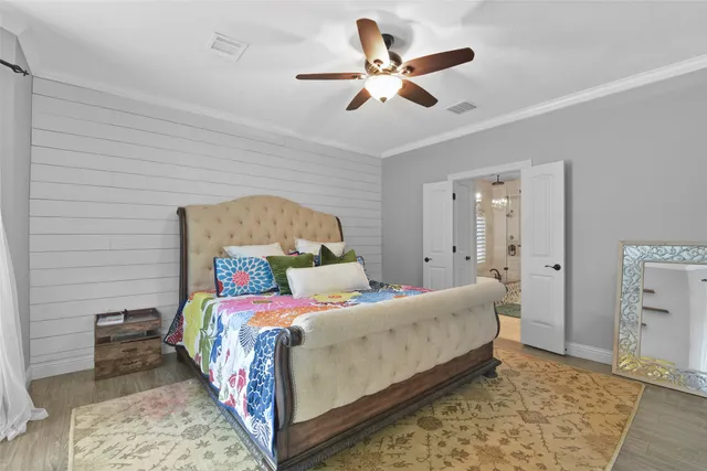 a bedroom with a bed and a chandelier