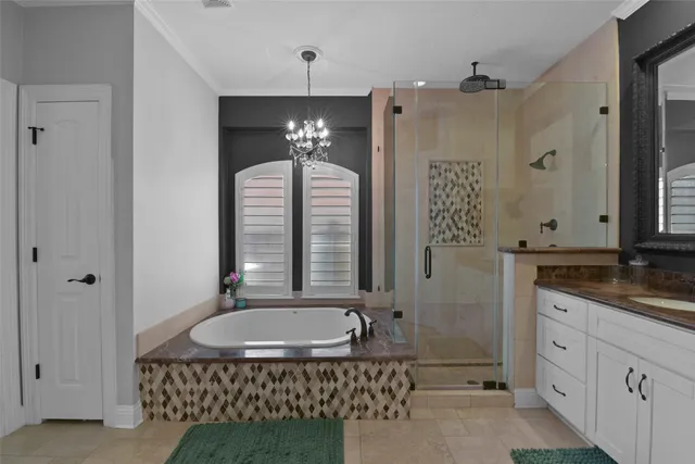 a bathroom with a granite countertop sink a mirror a bathtub and shower