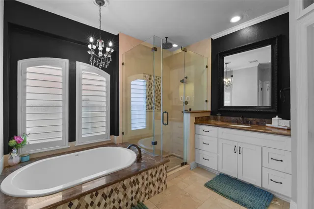 a bathroom with a granite countertop sink a large mirror and a bathtub