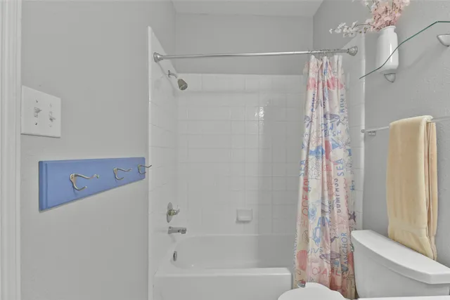 a bathroom with a shower curtain and a bathtub