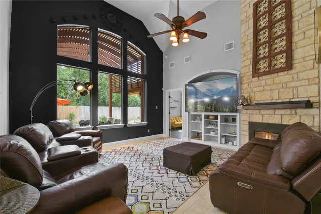 a living room with furniture fireplace and a large window