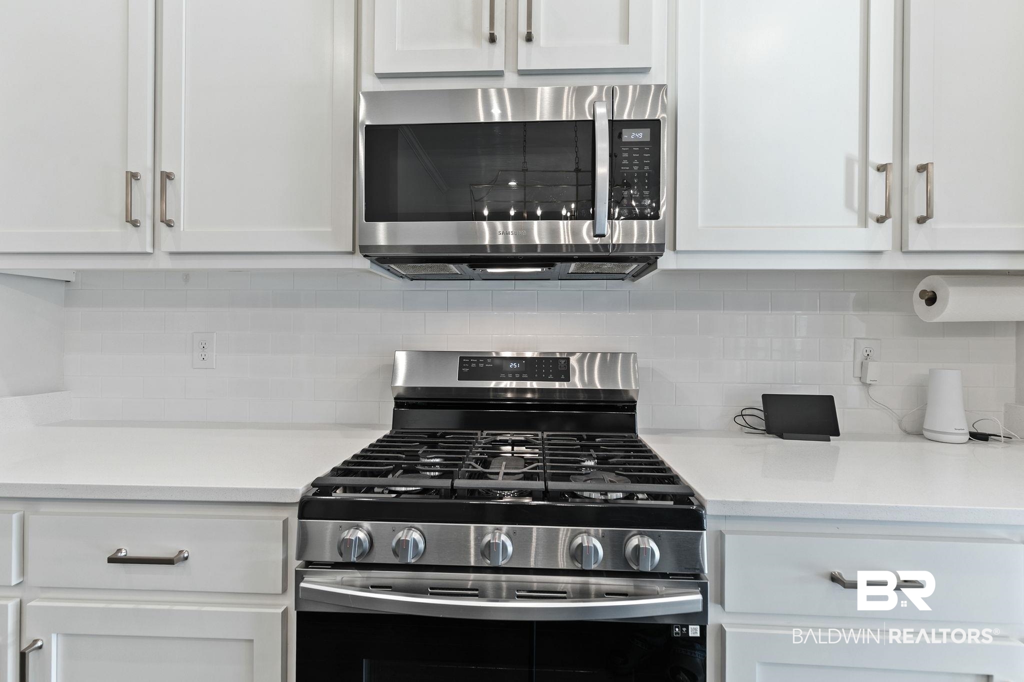 31654 Canopy Loop Daphne, AL 36527 - Photo 20 of 64 Kitchen featuring stainless steel appliances, white cabinets, and tasteful backsplash