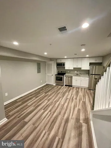 a view of kitchen and refrigerator
