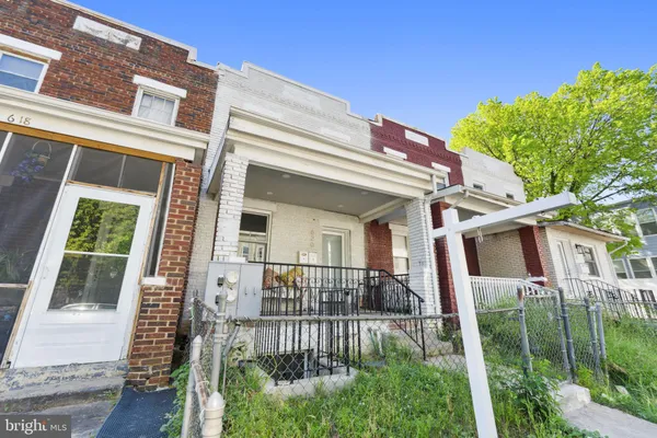 a view of a house with brick walls