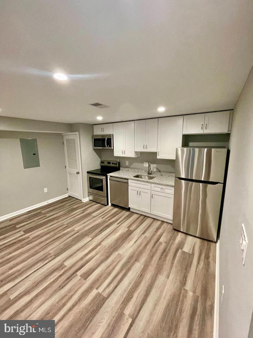 620 20th Street Northeast, Unit B Washington, DC 20002 - Photo 2 of 18 a kitchen with stainless steel appliances granite countertop a refrigerator sink and cabinets