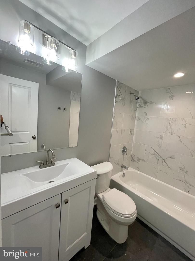 620 20th Street Northeast, Unit B Washington, DC 20002 - Photo 7 of 18 a bathroom with a sink a toilet a mirror and bathtub