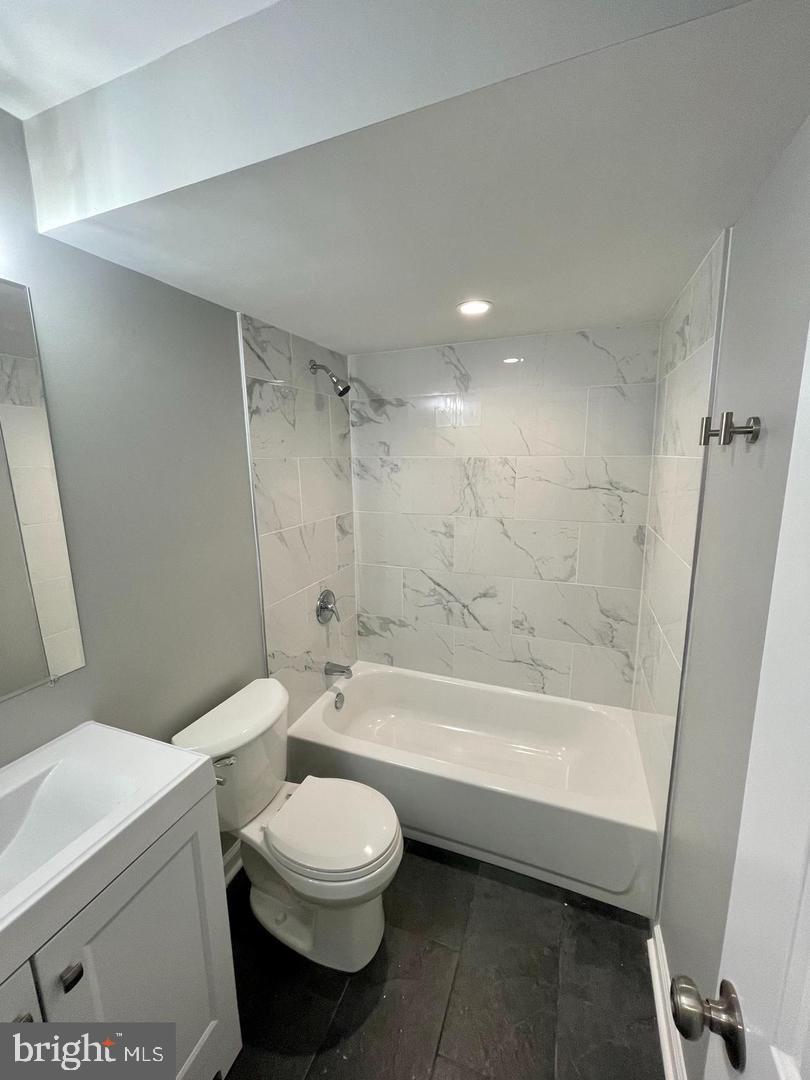 620 20th Street Northeast, Unit B Washington, DC 20002 - Photo 8 of 18 a bathroom with a toilet and a bath tub