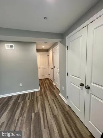 a view of a room with wooden floor