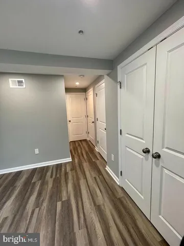a view of a room with wooden floor