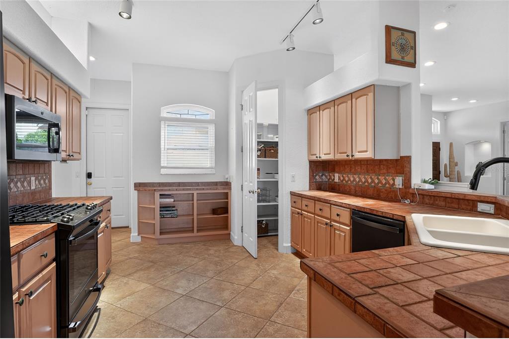 2968 Plantation Road Winter Haven, FL 33884 - Photo 19 of 81 a kitchen with granite countertop a stove top oven and cabinets