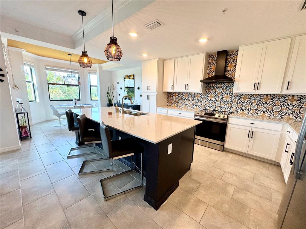 18028 Gawthrop Drive, Unit 303 Bradenton, FL 34211 - Photo 11 of 58 a kitchen with a sink a counter top space a stove a counter space and cabinets