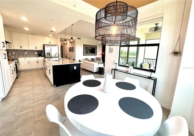 a kitchen with a table chairs stove and wooden floor