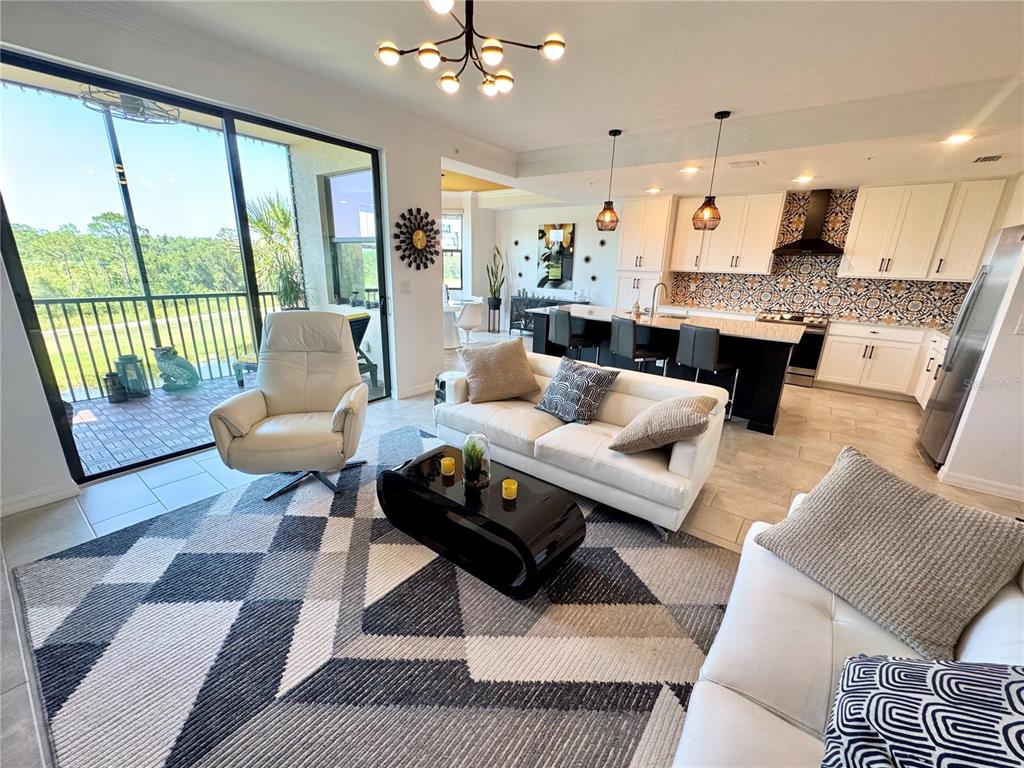 18028 Gawthrop Drive, Unit 303 Bradenton, FL 34211 - Photo 18 of 58 a living room with furniture and a large window
