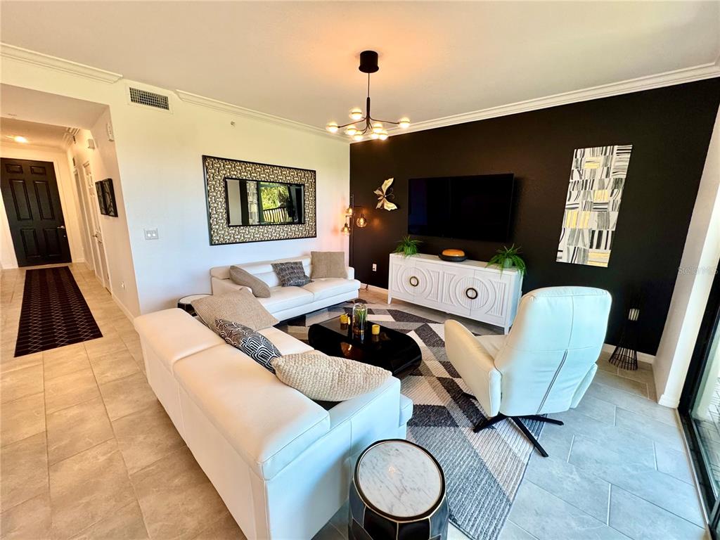 18028 Gawthrop Drive, Unit 303 Bradenton, FL 34211 - Photo 21 of 58 a living room with furniture and a flat screen tv