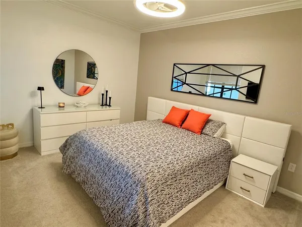 a bedroom with a bed and a painting on the wall