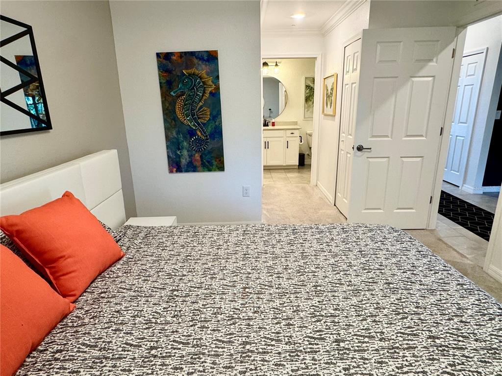 18028 Gawthrop Drive, Unit 303 Bradenton, FL 34211 - Photo 25 of 58 a bedroom with a bed and a rug
