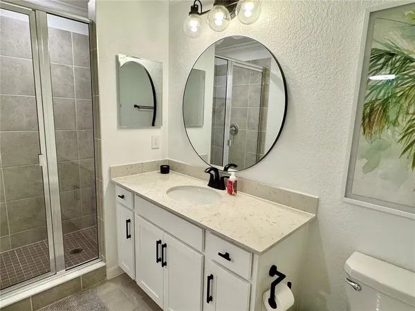 a bathroom with a sink a vanity and a mirror