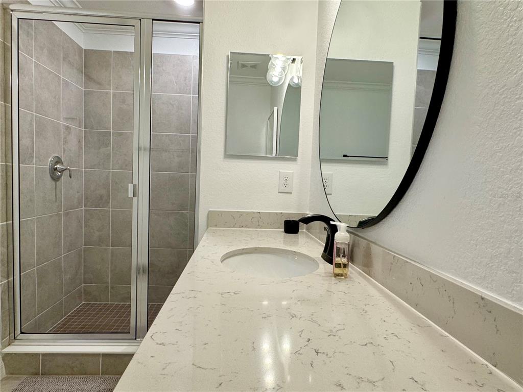 18028 Gawthrop Drive, Unit 303 Bradenton, FL 34211 - Photo 28 of 58 a bathroom with a sink and a mirror