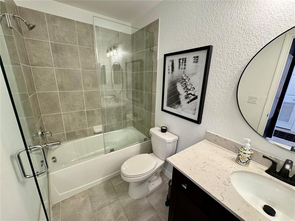 18028 Gawthrop Drive, Unit 303 Bradenton, FL 34211 - Photo 33 of 58 a bathroom with a sink a toilet and a mirror