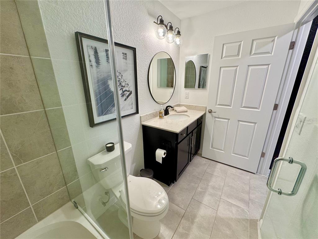 18028 Gawthrop Drive, Unit 303 Bradenton, FL 34211 - Photo 34 of 58 a bathroom with a toilet a sink and mirror