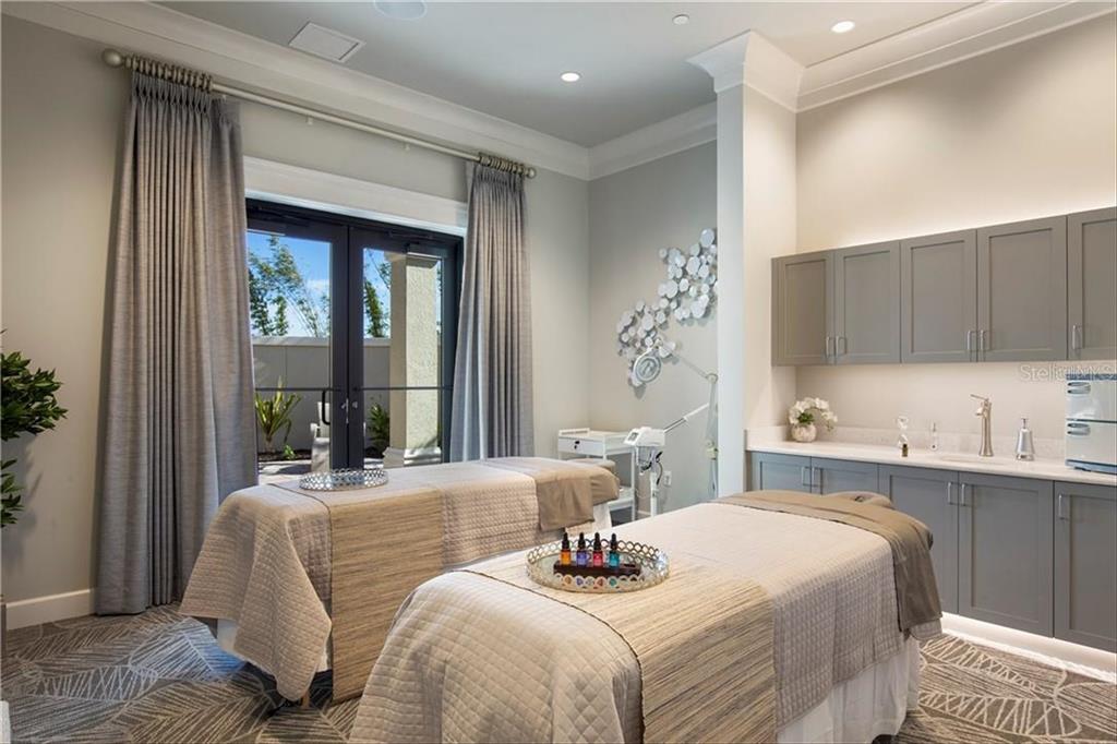 18028 Gawthrop Drive, Unit 303 Bradenton, FL 34211 - Photo 55 of 58 a bedroom with a large bed and a large window